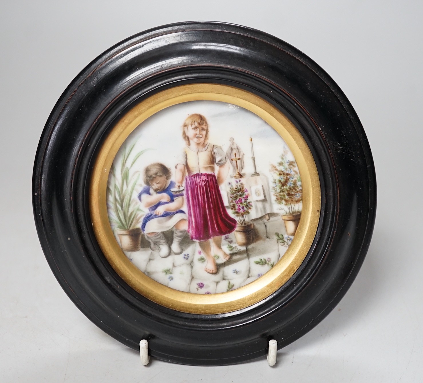 A 19th century Continental porcelain plaque. 16cm diameter overall